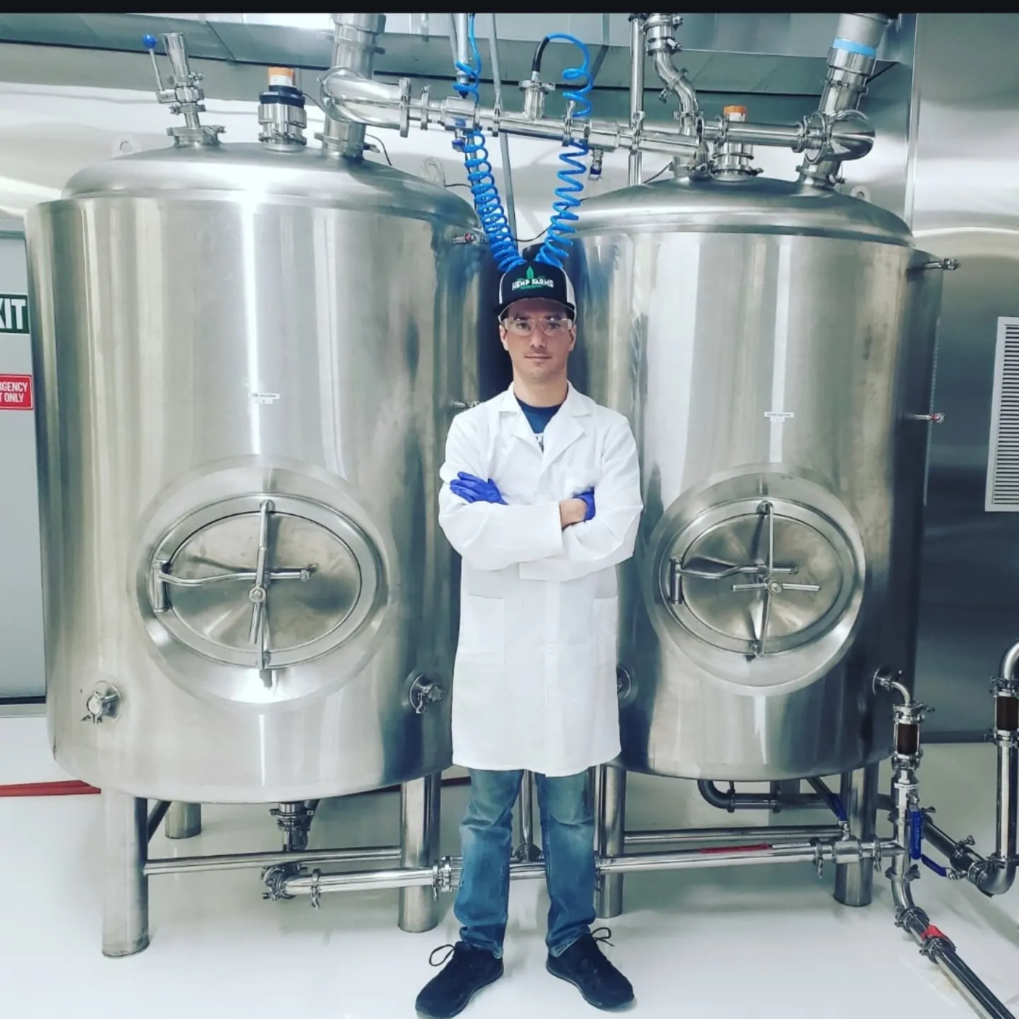 Brian Denovio standing in front of industrial extraction tanks
